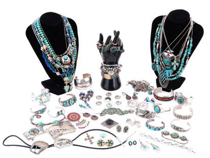 LOT OF NATIVE AMERICAN SILVER TURQUOISE JEWELRY: A lot of Native American jewelry mostly made of silver and set with natural semi precious stones like turquoise, carnelian, lapis lazuli, jasper, and other stones. The lot includes bangle bracelets,