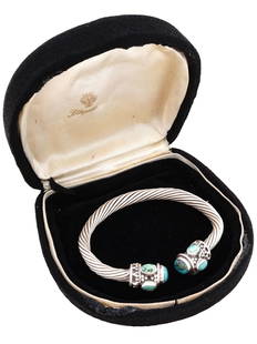 VTG AMERICAN DAVID YURMAN SILVER TURQUOISE CUFF BANGLE: A vintage American David Yurman sterling silver intertwined cuff bangle with turquoise stones at the ends. The use of sterling silver, known for its timeless appeal and durability, highlights the bang