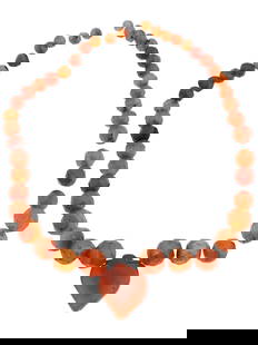 LATE ROMAN BYZANTINE FACETED CARNELIAN BEADED NECKLACE: An ancient late Roman or Byzantine faceted carnelian beaded necklace. Carnelian, a semi-precious gemstone, was highly regarded in ancient times for its rich, translucent red to orange-red hues, and it