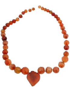 LATE ROMAN BYZANTINE FACETED CARNELIAN BEADED NECKLACE: An ancient late Roman or Byzantine faceted carnelian beaded necklace. Carnelian, a semi-precious gemstone, was highly regarded in ancient times for its rich, translucent red to orange-red hues, and it