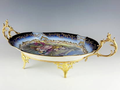 LARGE 19TH C FRENCH SEVRES PORCELAIN CENTERPIECE: A large antique French 19th century Sevres porcelain and gilt bronze centerpiece or platter. All hand painted with raised gold floral decor around the rim. Signed by the artist lower right. Double han