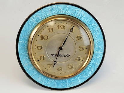 TIFFANY AND CO SILVER ENAMEL SWISS ALARM CLOCK: A vintage Swiss made alarm clock with silver and turquoise guilloche enamel frame with palmette patterns and a brass body. The dial is signed: Tiffany and Co., 8 days, Swiss made. Collectible Luxury C