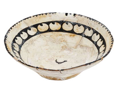 ANCIENT ISLAMIC MIDDLE EAST 8TH C AD POTTERY BOWL: A large Samanid slip-painted pottery bowl of conical form raised on a short foot, adorned to the interior in brown manganese on a cream slip with two abstract decorative bands and a symbol in the cent
