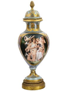 LARGE ANTIQUE ROYAL VIENNA PORCELAIN GILT COVERED VASE: A large antique Royal Vienna porcelain gilt mounted covered vase, featuring a central hand painted panel that depicts a goddess surrounded by cherubs. This masterpiece of porcelain artistry exemplifie