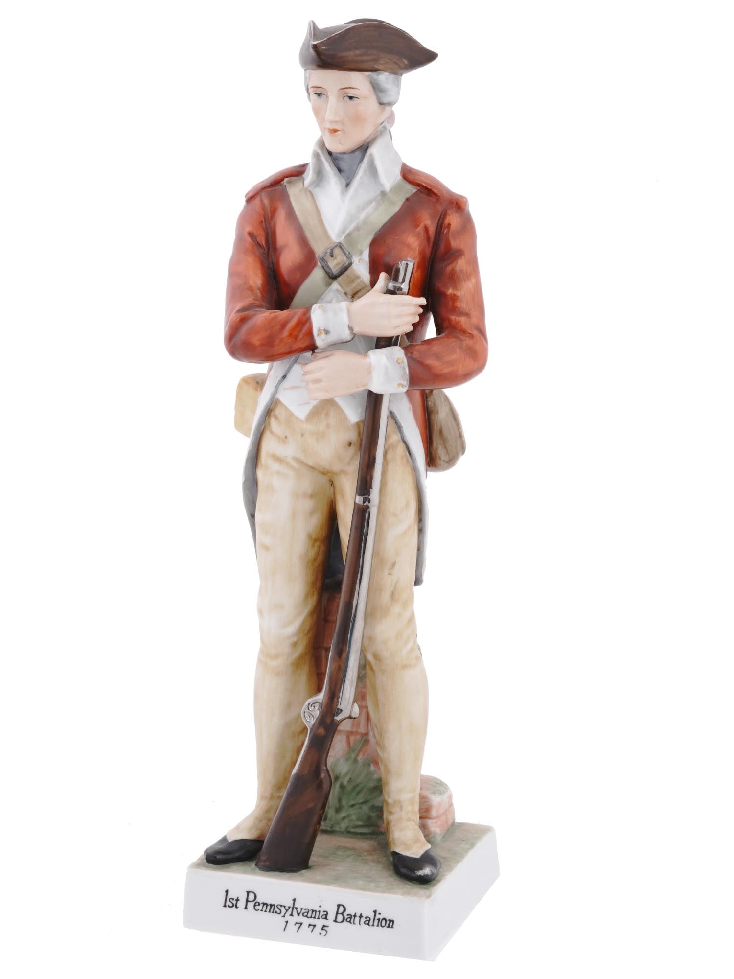 RARE PENNSYLVANIA PORCELAIN MILITARY FIGURE OF SOLDIER: A rare hand painted porcelain military figurine. The figurine depicts a soldier in uniform holding a weapon, 1st Pennsylvania Battalion 1775 Revolutionary War. The figurine is covered with polychrome 