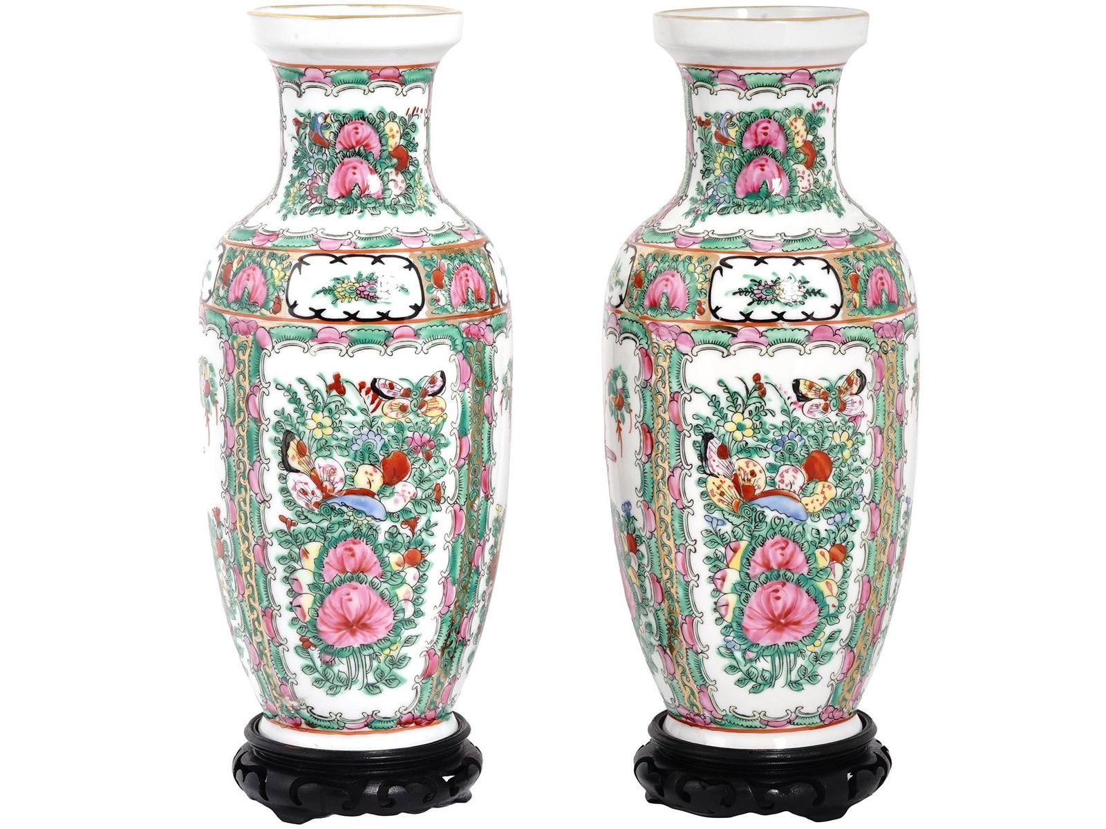 CHINESE FAMILLE ROSE PORCELAIN VASES WITH STANDS: A pair of vintage tall Chinese white porcelain vases with hand-painted Famille rose decor and gilt rims. Each vase has a carved wooden stand. Hieroglyphical hallmark is on the bottom of both items. Co