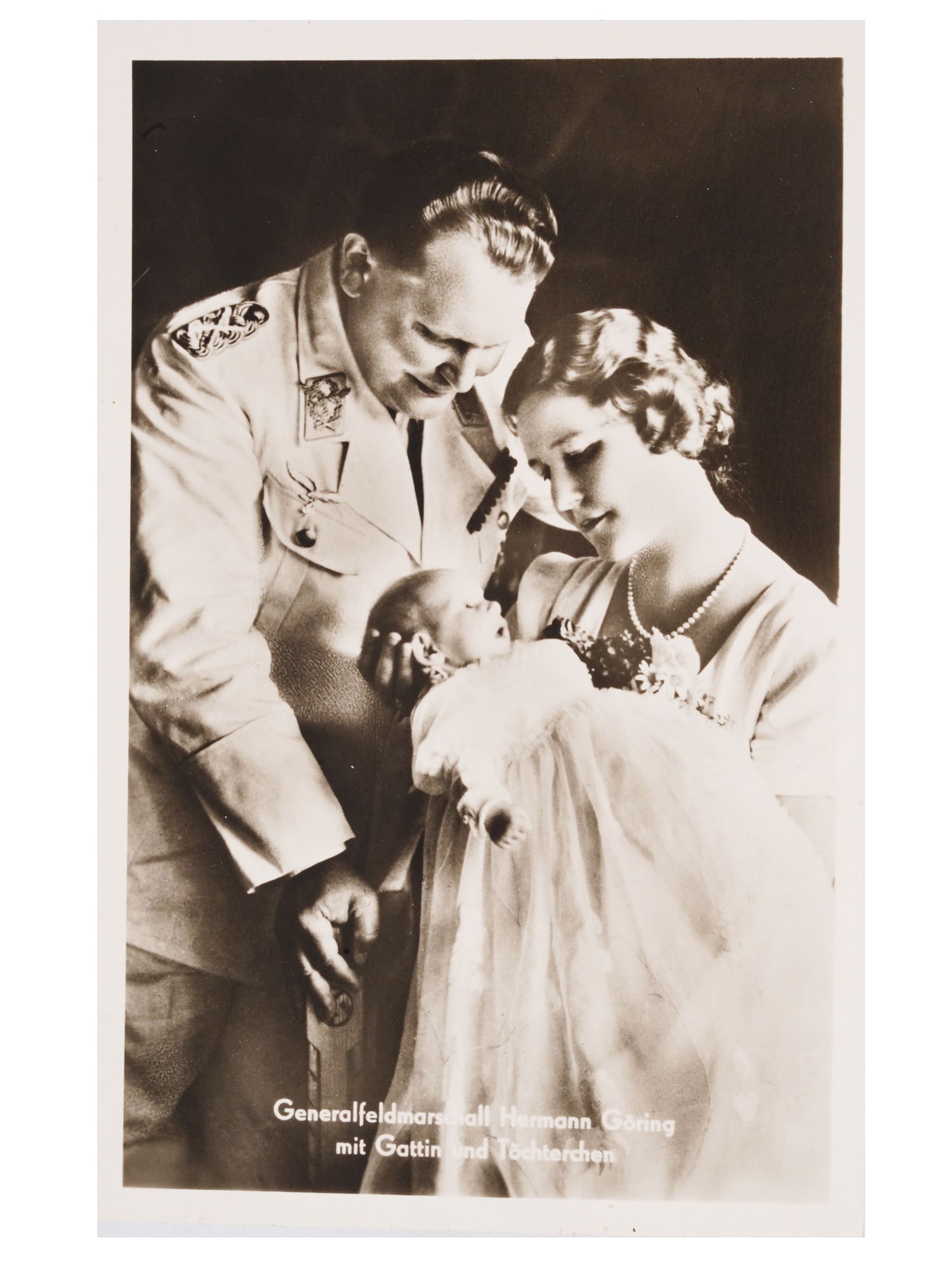 PRE WWII NAZI GERMAN GOERING AND FAMILY POSTCARD PHOTO: A pre WWII Nazi German postcard, featuring a 1938 photograph of Field Marshal Hermann Goering with his wife Emmy and their baby daughter Edda, providing a glimpse into the personal life of a prominent