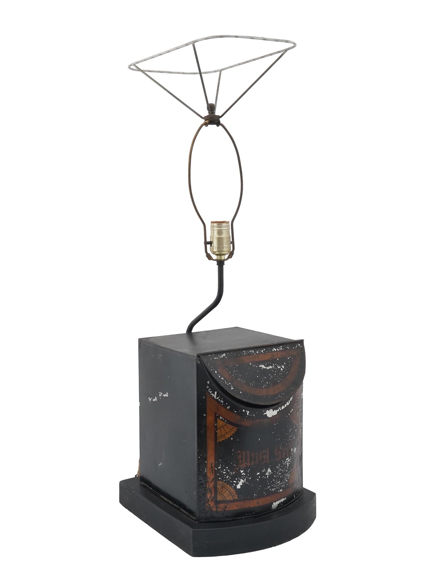 ANTIQUE MUSTARD SEED TIN CAN DESK LAMP WITH SHADE: An electrical table lamp made of an antique early 20th century tin can for mustard seeds. The can is black and has a bronze-toned geometrical design with inscription Must. Seed. There is a handwritten