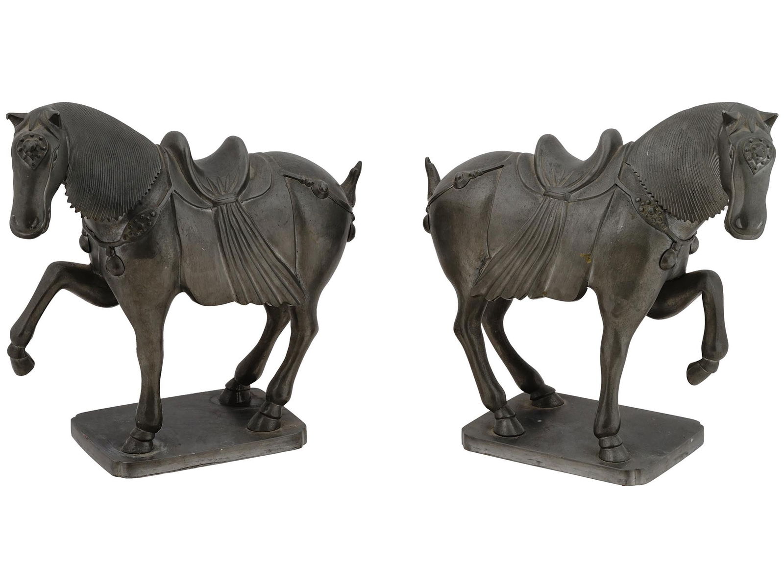 VINTAGE CHINESE TANG PEWTER HORSE FIGURES: A pair of vintage Chinese Tang decorative pewter figurines, each depicts a horse with tassels and molded saddle, on a rectangular base. Made in Hong Kong. Marked underneath. Circa the 1970s. Vintage C