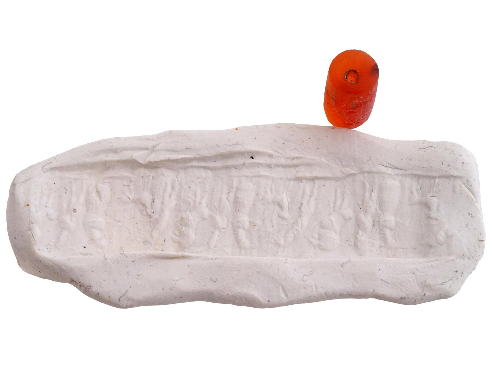 MESOPOTAMIAN CARNELIAN CYLINDER SEAL W IMPRESSION: An ancient Near East, Mesopotamia, Sumer, hand carved Carnelian stamp seal. The cylindrical form seal is adorned with engraved detailed patterns. Completed with a custom putty impression depicting hum