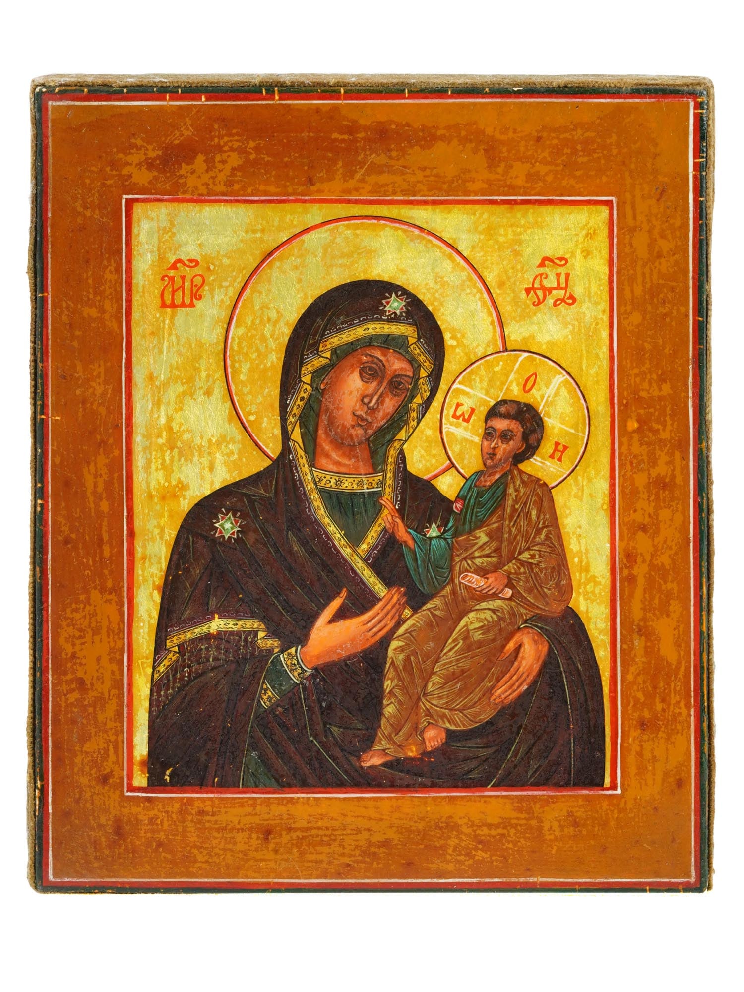 ANTIQUE RUSSIAN ORTHODOX MOTHER OF GOD OF KAZAN ICON: An antique Russian Orthodox icon of the Mother of God, known as the Theotokos of Kazan. The icon depicts the Virgin Mary holding the Christ Child in her arms. Tempera and gold on a wooden panel. Our L