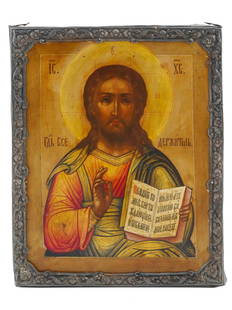 ANTIQUE RUSSIAN ICON JESUS CHRIST IN SILVER FRAME: An antique 19th-century Russian Orthodox icon of Jesus Christ in Pantocrator iconography, known in the Western Christianity as Christ in Majesty. Mixed media painting: egg tempera, gesso, and levkas