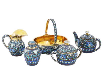 RUSSIAN SILVER GILT CLOISONNE ENAMEL TEA SET: A fine quality Russian enameled silver gilt tea set comprising five items. The set includes a teapot, a creamer, a candy bowl or a centerpiece, a sugar bowl and a tea caddy. The exterior of each item