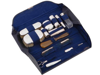 ANTIQUE CARTIER STERLING SILVER VANITY SET: Antique vanity set of sterling silver accessories, elegantly curated for the sophisticated user. The set includes a variety of essential grooming tools such as scissors, brushes, a nail file, a mirror