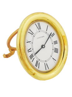 VINTAGE CARTIER GOLD COLOR ALARM TABLE CLOCK: A vintage Cartier gold color alarm table clock, exuding timeless elegance with its enamel dial and classic Roman numerals. This exquisite piece combines the prestigious Cartier design with the functio