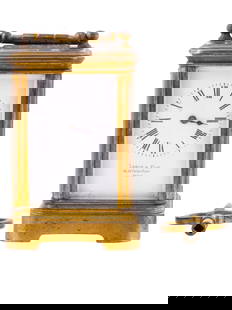 ANTIQUE FRENCH LEROY GILT BRONZE CARRIAGE CLOCK: A miniature antique 19th-century French carriage clock with key wind mechanism. Footed rectangular case with a handle on top made of gilt bronze. Clear glass sides display the clock mechanism. White e