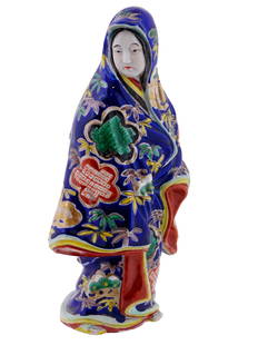 ANTIQUE JAPANESE SATSUMA PORCELAIN FEMALE FIGURE: An antique Japanese hand-painted porcelain figurine. Late Edo period, mid-19th century. The piece represents a Buke Musume, Samurai Daughter, a young woman in a richly decorated cobalt blue mantle. Ra