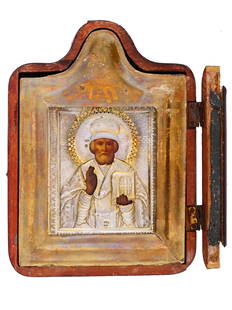 ANTIQUE RUSSIAN ICON OF ST NICHOLAS IN SILVER RIZA: An antique late 19th-century Russian Orthodox icon representing Saint Nicholas of Myra, also known as the Wonderworker, with the blessing figures of Virgin Mary and Jesus Christ. Mixed media