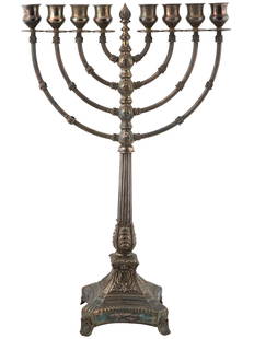 ANTIQUE JUDAICA STERLING SILVER MENORAH CANDLE HOLDER: An antique 19th century silver menorah, a multi-branched candelabra used during the celebration of Hanukkah. The piece represents a footed stand with embossed decoration and 8 branches supporting cand