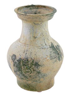 ANCIENT CHINESE HAN DYNASTY GREEN GLAZED VASE: An ancient glazed vase from the Chinese Han Dynasty period. The vase is of traditional round shape with a flaring rim. The sides are applied with taotie handles. The Han Dynasty, 206 BC to 220 AD was