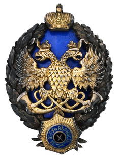 RUSSIAN GILT SILVER ENAMEL BADGE OF COURT HUNTING: A Russian Imperial gilt silver enamel badge of court hunting. Features a double headed eagle clutching horns on a blue enamel ground in a wreath, crowned. With a miniature of the Order of St. Andrew t