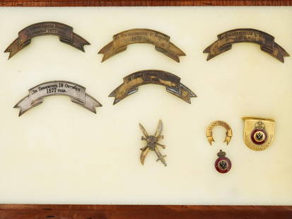 IMPERIAL RUSSIAN MILITARY BADGES IN DISPLAY CASE: A lot of late 19th to early 20th century Imperial Russian military insignia. A total of 9 items, including two awards For Bravery, an Imperial Eagle badge, a WWI 31st Corps Aviation Detachment pin, an