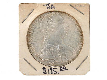 1870 AUSTRIAN MARIA THERESIA ONE THALER SILVER COIN: An antique 1870 Austrian Empire Maria Theresia one Thaler silver coin. The obverse shows a bust of Empress Maria Theresia of Habsburg facing right, wearing a veil, tiara, and pearl brooch. The letteri