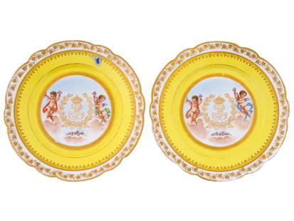 ANTIQUE 19TH C FRENCH SEVRES PORCELAIN PLATES: A pair of antique French Sevres Chateau des Tuileries porcelain cabinet plates, featuring a cypher for Louis-Philippe framed by laurel leaves, flanked by hand-painted cherubs and gilt decoration to th