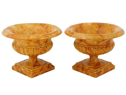 ANTIQUE ITALIAN CARVED MARBLE TAZZAS GARDEN URNS: A pair of antique Italian Sienna marble tazzas. The urn form with wide molded rims above sharply waited sides, the shoulders with a wide gadroon band, over turned and molded pedestal on a square