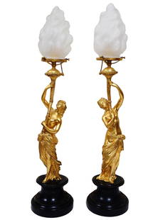 ANTIQUE FRENCH GILT BRONZE LAMPS BY AUGUSTE MOREAU: A pair of antique gilded bronze lamps by Auguste Moreau. Lamps with figural stems modeled as a pair of beautiful, very similar ladies in light flowing fabrics, who hold stylized torches in their