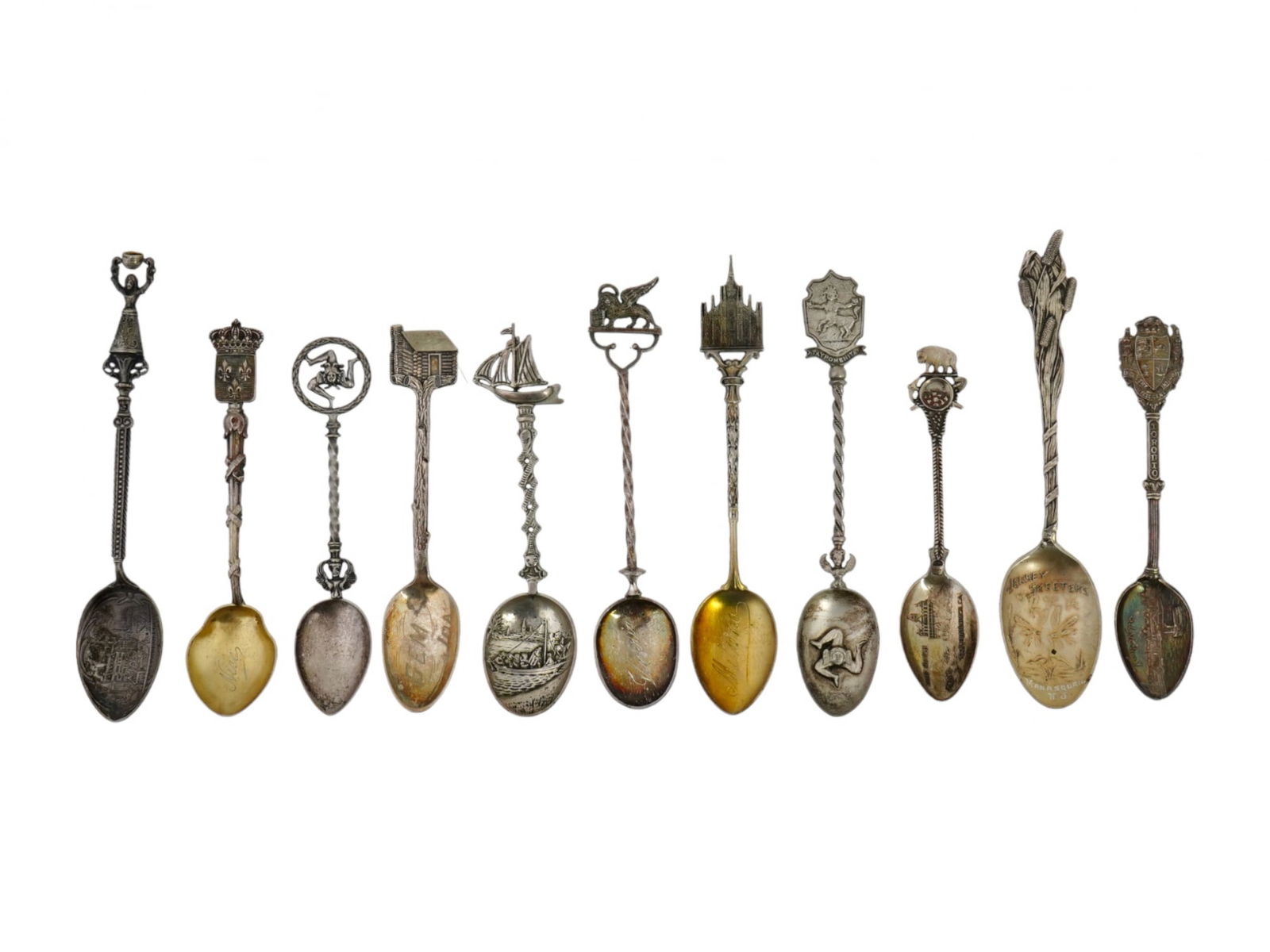 ANTIQUE DIFFERENT COUNTRIES SILVER SOUVENIR SPOONS: A set of eleven antique engraved silver tea spoons from different countries. All teaspoons in this set are uniquely decorated with symbols and landmarks of the countries from which they were brought.