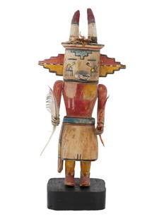 NATIVE AMERICAN KACHINA HOPI HAND CARVED WOOD DOLL: A Southwestern Native American Kachina Hopi doll with horns. The doll is made from hand carved wood. The figurine is adorned with hand painted traditional ornaments, and decorated with feathers in han