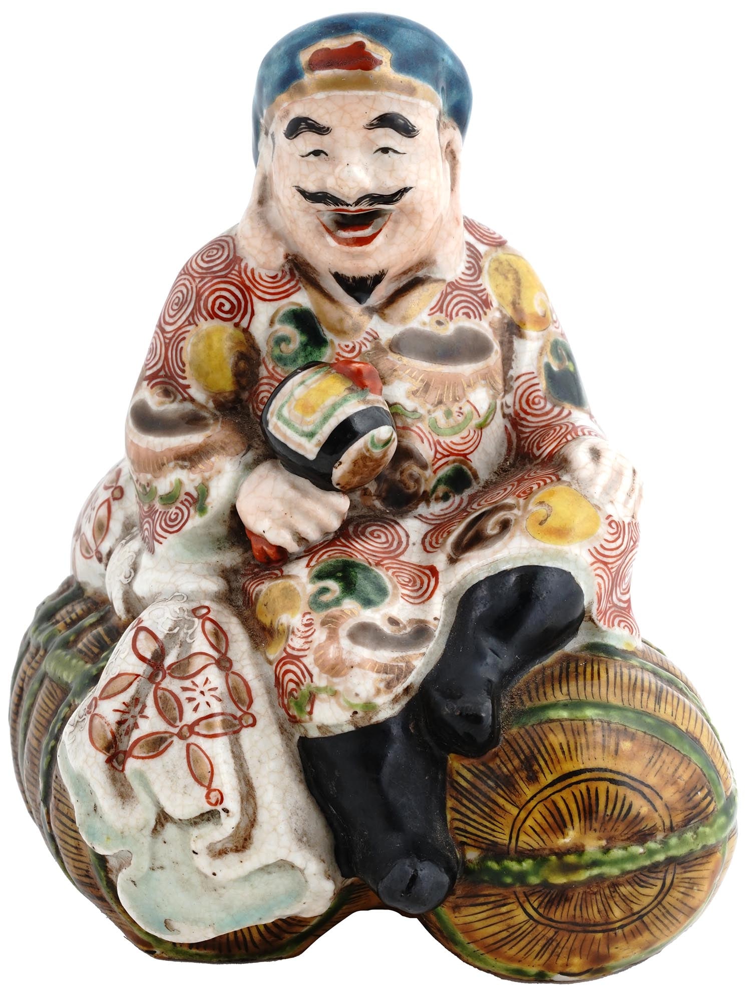 JAPANESE MEIJI GLAZED PORCELAIN DAIKOKU FIGURINE: An antique Japanese hand-painted glazed porcelain figure. Late Meiji era, before 1912. The piece represents Daikokuten, the syncretic Japanese deity of fortune and wealth. He is portrayed as a smiling