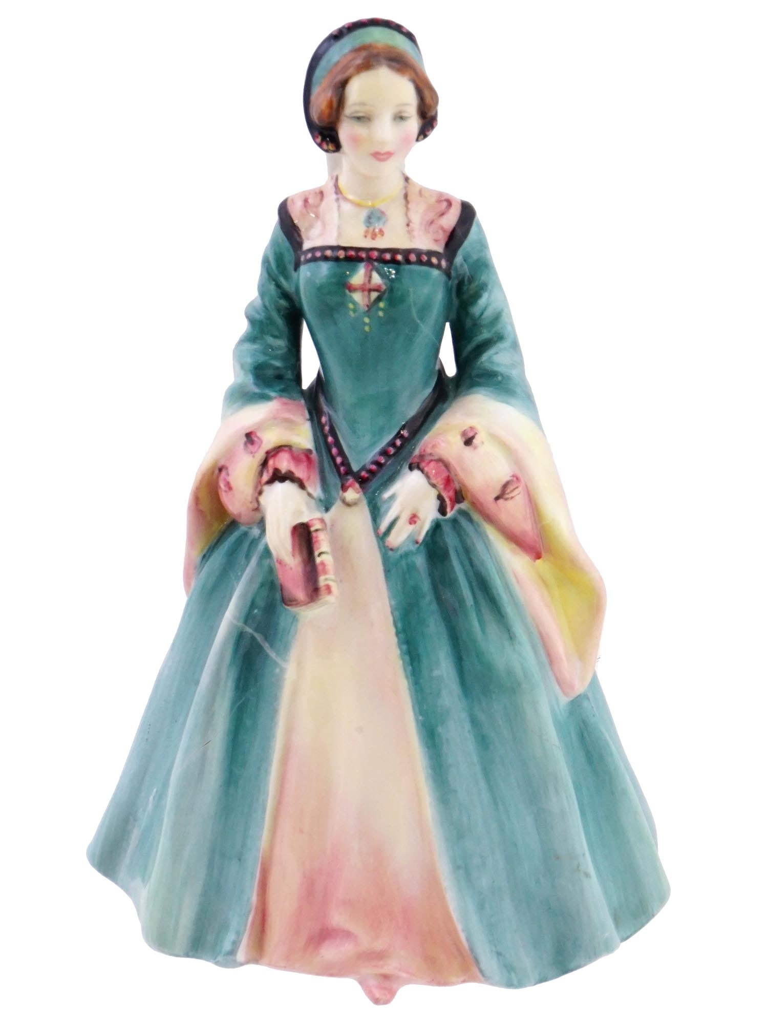 ENGLISH ROYAL DOULTON JANICE LADY PORCELAIN FIGURINE: An English Royal Doulton hand enameled polychrome glazed porcelain figurine, Janice, depicting a lady in a dress and a headdress holding a book. Marked with a Royal Doulton manufacturer mark, made in 