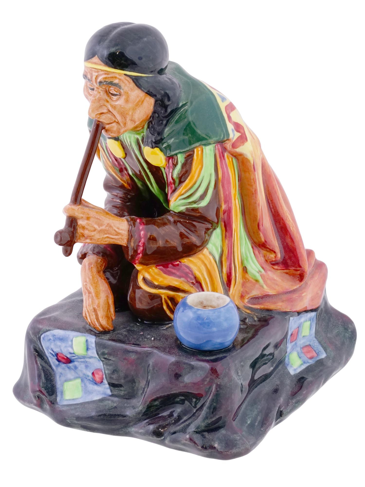 ENGLISH ROYAL DOULTON PORCELAIN CALUMET FIGURINE: An English Royal Doulton polychrome glazed porcelain figurine, Calumet, designed by Charles Noke as part of the Native American Heritage series. The figurine is marked with a Royal Doulton manufacture