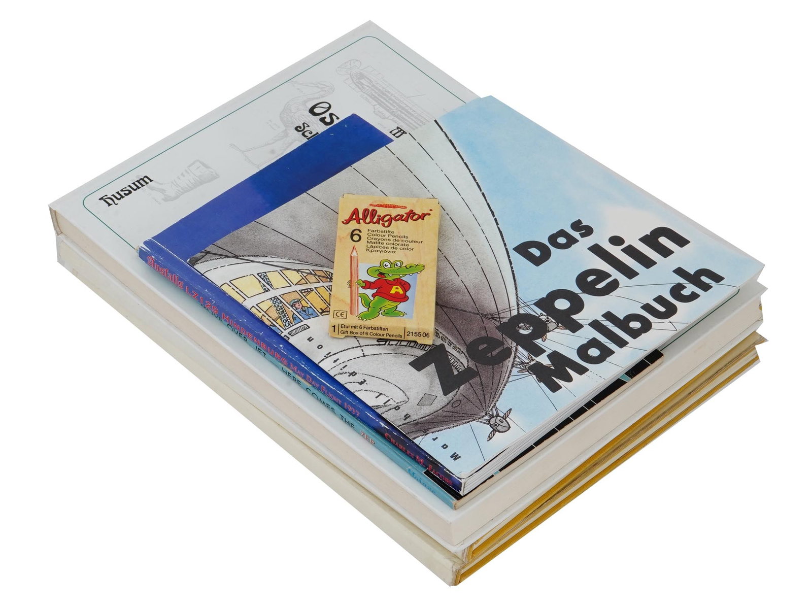 GROUP OF VINTAGE ZEPPELIN BOOK EDITIONS AND MEMORABILIA: A group of vintage Zeppelin literature and cultural memorabilia. This lot includes a rare 1964 publication Zeppelin Caterpilar by Zeppelin Metallwerken GMBH, The Zeppelin Colouring Book for enthusiast