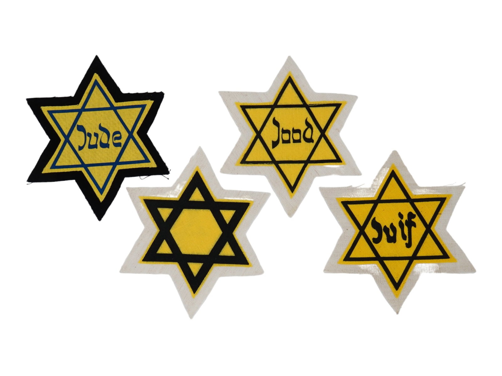 GROUP OF 4 HOLOCAUST PERIOD STARS OF DAVID ARMBANDS: A lot of four World War II fabric armbands in the shape of the Star of David. Three of the items have inscription Jew in German, Dutch, and French. During the World War II Jewish people living in Germ
