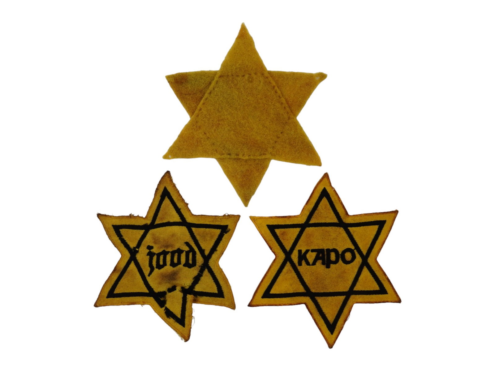 GROUP OF 3 HOLOCAUST PERIOD STARS OF DAVID ARMBANDS: A group of 3 Holocaust period Stars of David fabric armbands. One piece is inscribed, Jood, the other is inscribed Kapo, and one has no inscription. During World War II Jewish people living in Germany