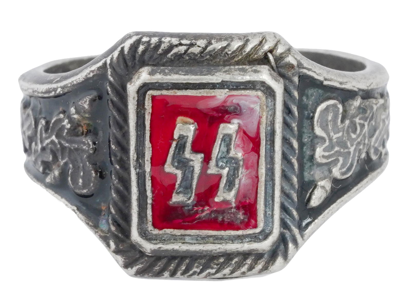 GERMAN WWII WAFFEN SS SILVER RING: A Second World War German Waffen SS Officers Silver ring. The ring is adorned with SS runes, and covered with enamel in a ruby red shade. The ring features an image of oak leaves and covered with enam