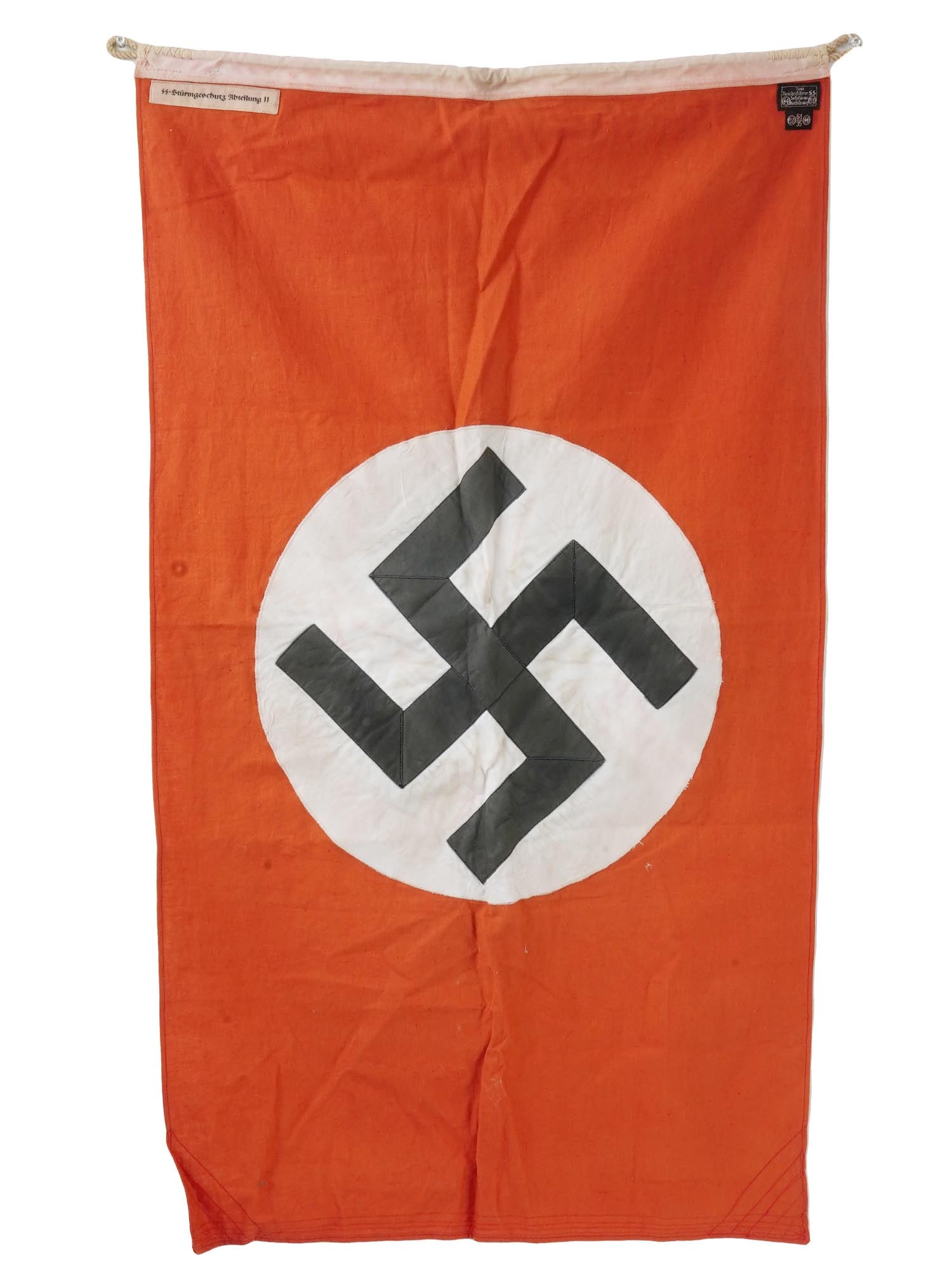 GERMAN WWII FLAG OF THE WAFFEN SS DIVISION NORDLAND: A WWII Nazi German Third Reich white, red, and black cotton flag of the Waffen SS Panzergrenadier Division Nordland. The flag features a swastika insignia. Marked with a sewn tag, SS Sturmgeschutz Abt