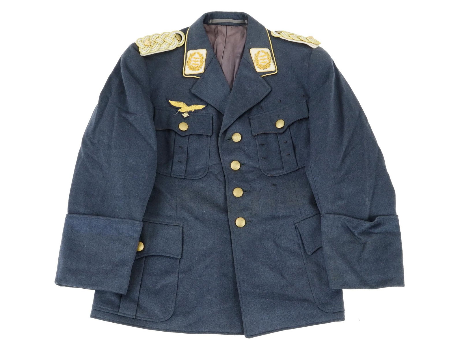 WWII NAZI GERMAN LUFTWAFFE GENERALS TUNIC: A WWII Nazi German Luftwaffe Generals tunic, this meticulously tailored garment exudes the distinguished elegance and authority associated with high-ranking officers of the Luftwaffe. Crafted with pre