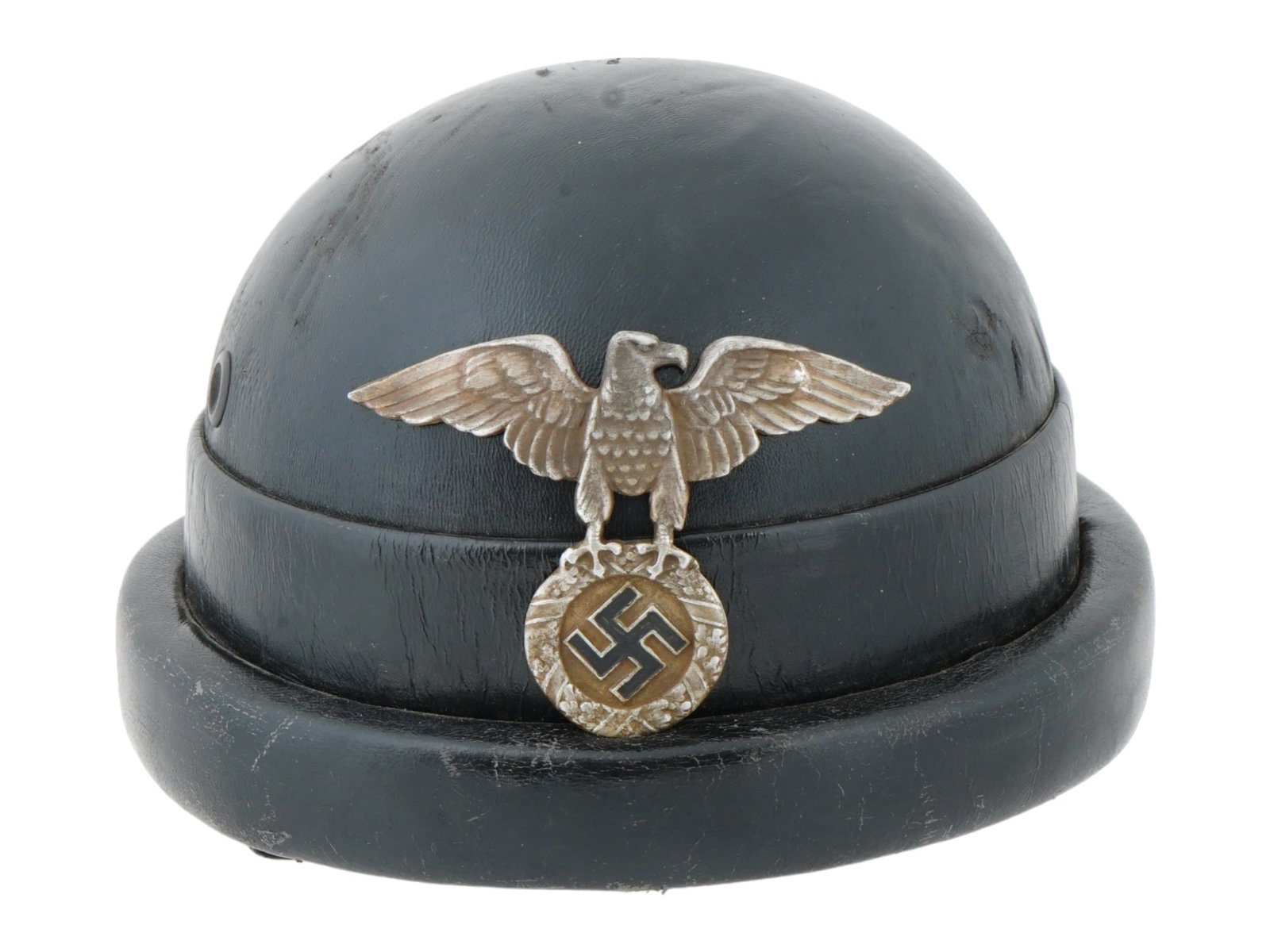 WWII NAZI GERMAN NSKK MOTORCYCLE HELMET: A WWII Nazi German NSKK National Socialist Motor Corps motorcycle helmet, an emblem of the era, featuring the eagle clutching a swastika within a wreath insignia. This rare artifact bears the symbolic