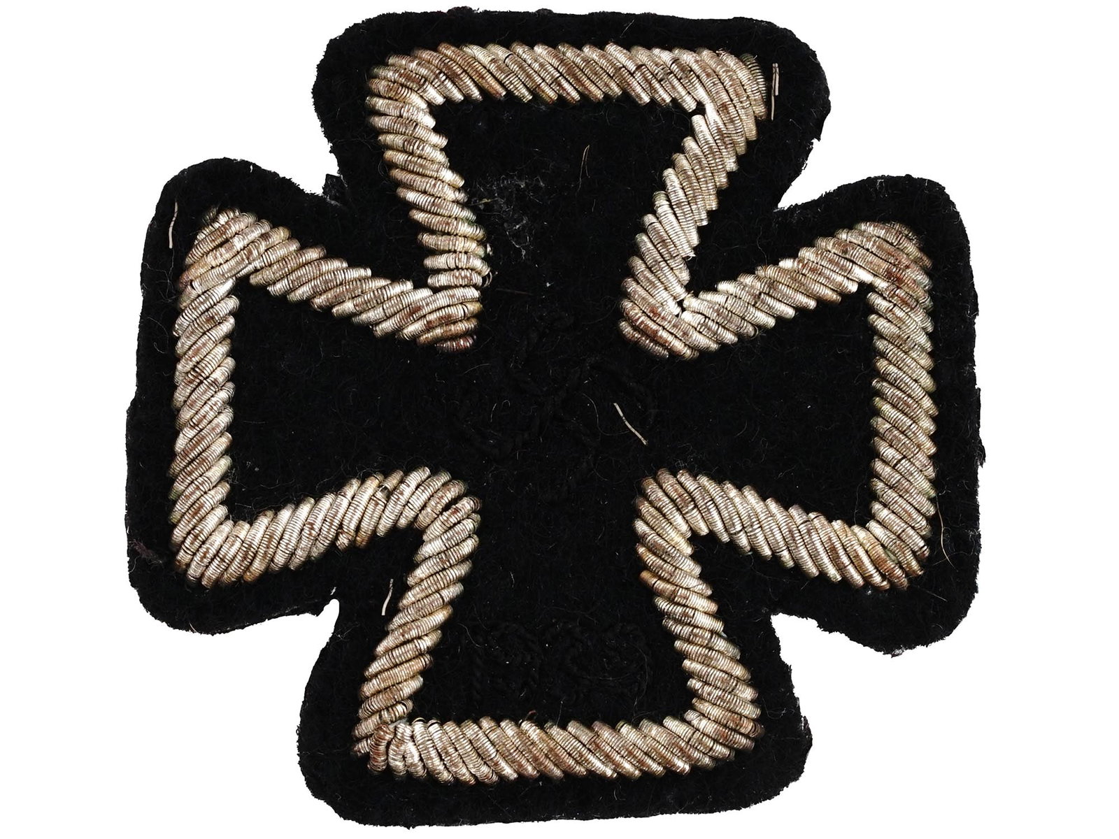 WORLD WAR II NAZI GERMAN IRON CROSS PATCH: A World War II Nazi German Iron Cross patch with an embroidered rim. Though unpopular with the troops, photographic evidence shows they existed. Appears to have been removed from a tunic. Second World