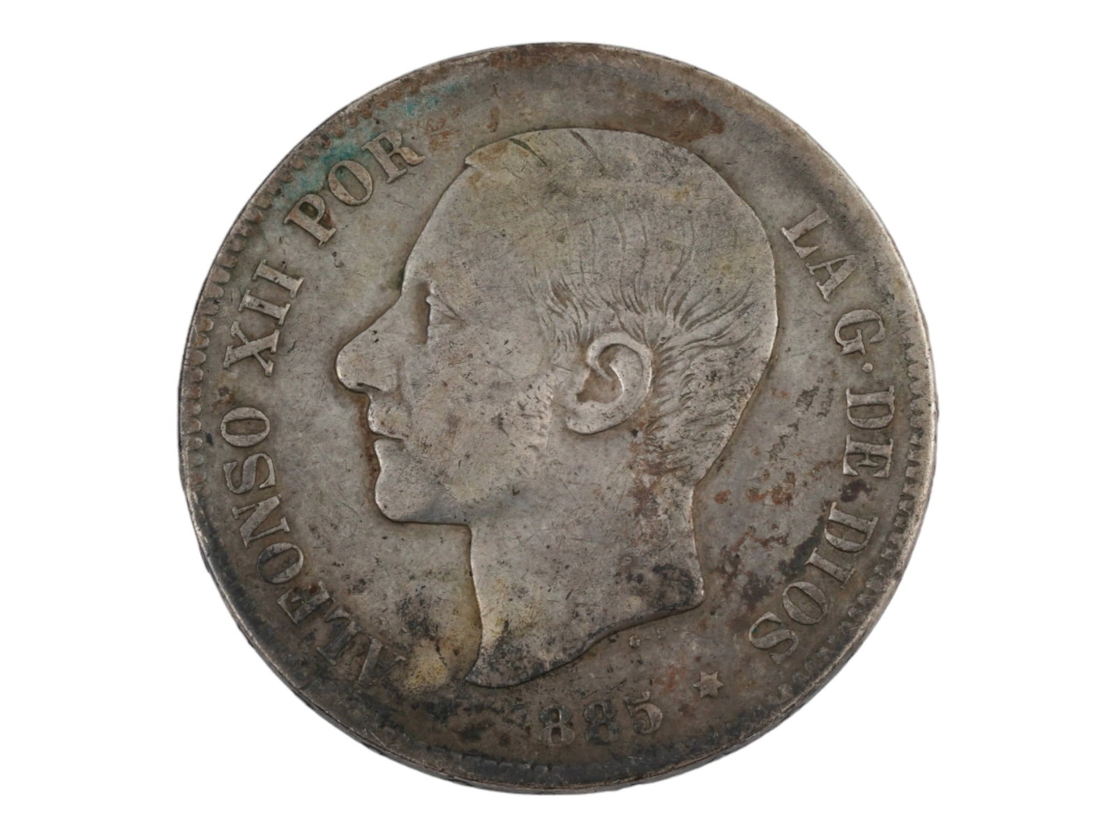ANTIQUE 1885 SPANISH ALFONSO XII 5 PESETAS SILVER COIN: An antique 1885 Spanish Alfonso XII 5 pesetas silver coin featuring a numismatic treasure with historical significance. This coin shows the bust of King Alfonso XII on the obverse, facing left, with t