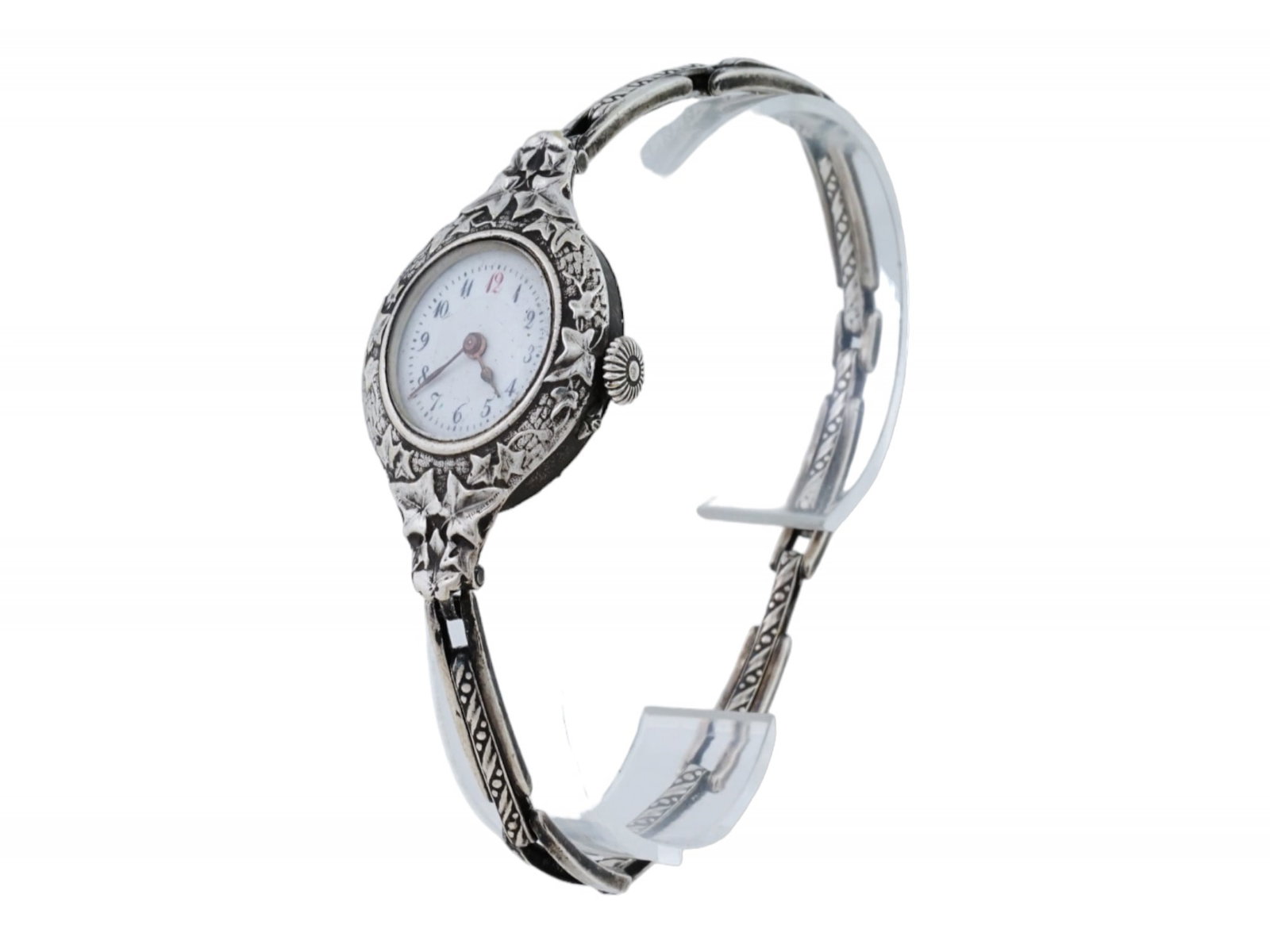 ANTIQUE 935 STERLING SILVER WOMENS WRISTWATCH: An antique Art Deco 935 sterling silver womens wristwatch. The watch of European origin, richly decorated with a relief pattern of intertwining ivy leaves around the dial. The dial field is white, ova
