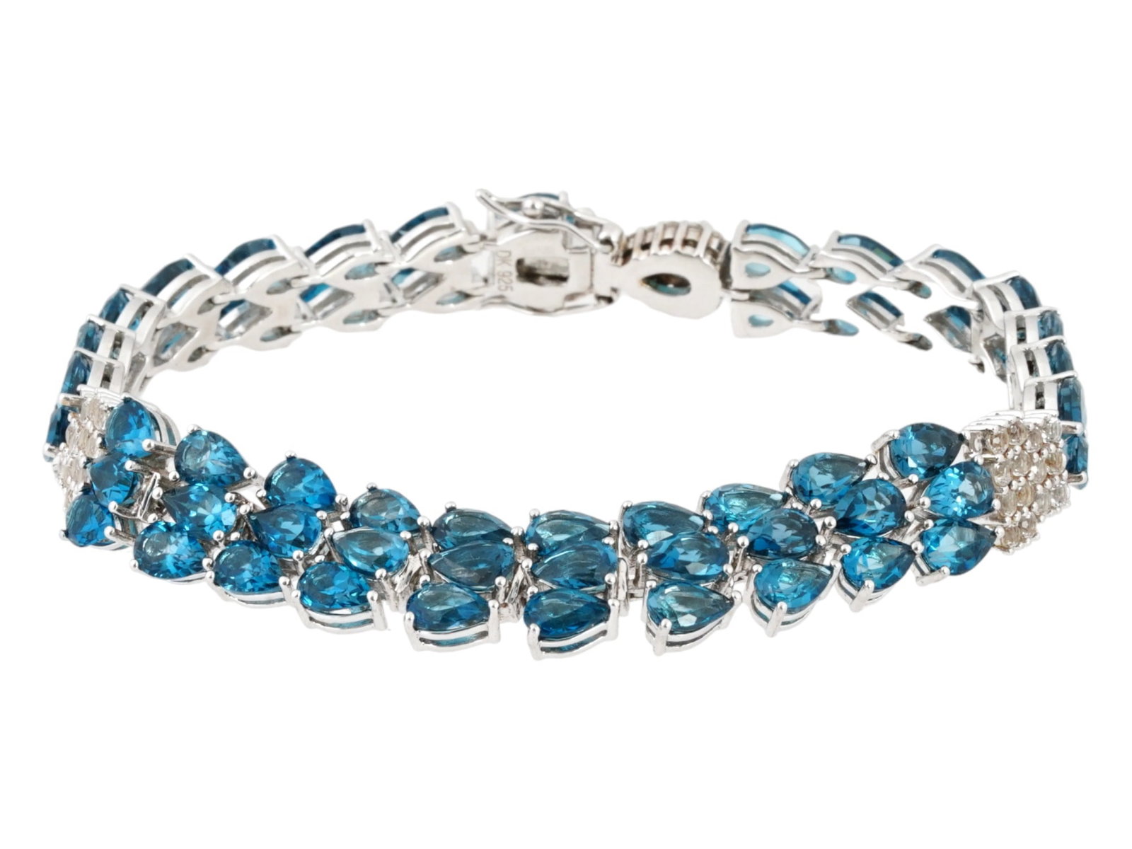 DAVID KIDD STERLING SILVER BLUE TOPAZ BRACELET: A vintage sterling silver cocktail bracelet. The piece is composed of drop-cut blue topaz stones and round-cut cubic zirconia. Marked DK for David Kidd, 925 on the clasp. Total Weight: 25 grams. Elega