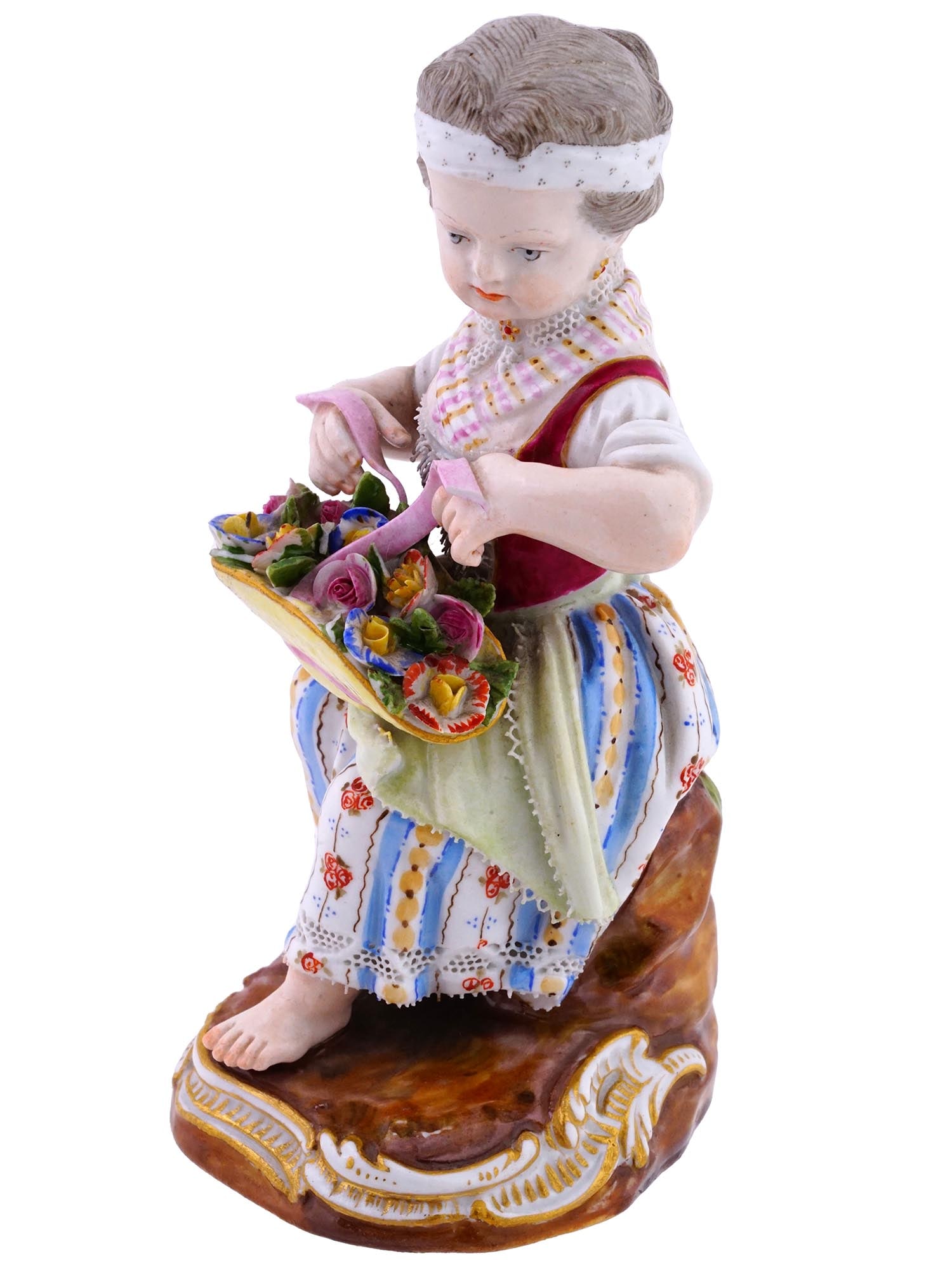 ANTIQUE GERMAN MEISSEN PORCELAIN GIRL FIGURINE: An antique German Meissen porcelain figurine, portraying a girl holding her hat filled with delicate flowers. Meticulously crafted and hand-painted, this piece exemplifies the timeless beauty and arti