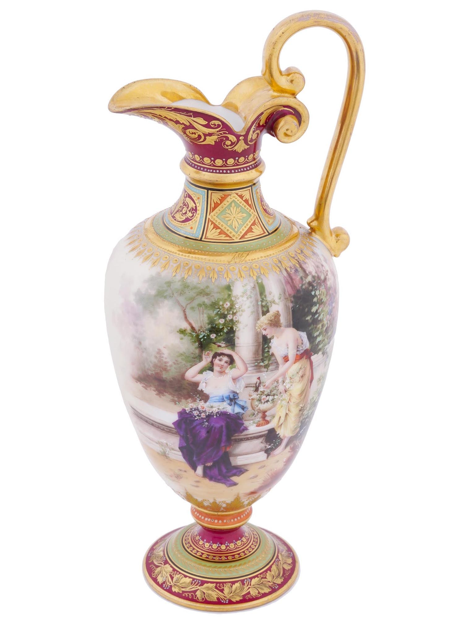 ANTIQUE ROYAL VIENNA CUPIDS PORCELAIN VASE EWER: An antique Royal Vienna hand painted porcelain vase ewer with a curved handle. The exterior of the ware is adorned with hand painted Neoclassical scenes with young women in a garden and a pair of cupi