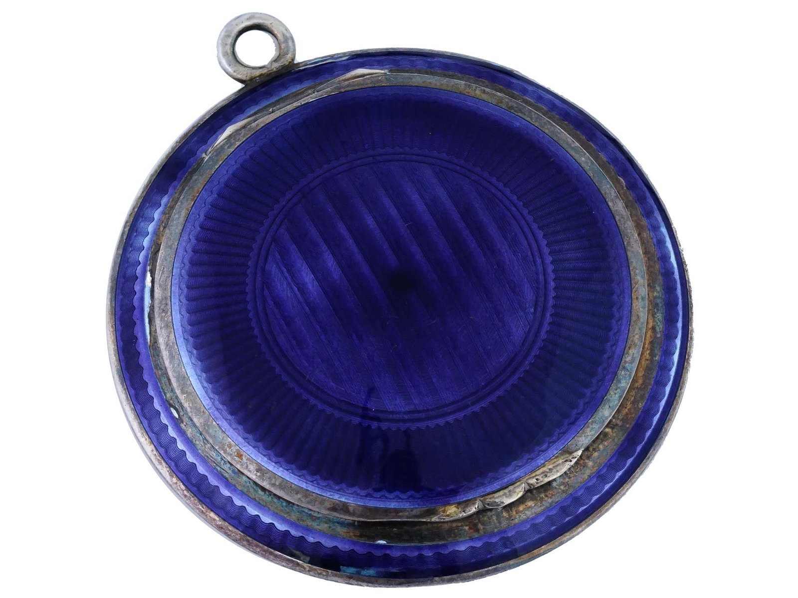 ANTIQUE STERLING SILVER GUILLOCHE ENAMEL PILL BOX: An antique English Sterling Silver and enamel pill box. The exterior of the ware is covered with a Guilloche enamel in a cobalt blue shade. Marked with an impressed hallmark, inside. A fitting ring fo