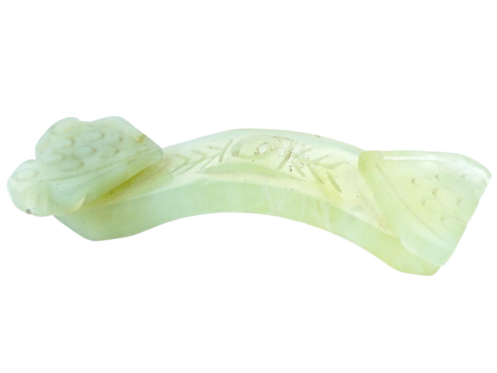 ANTIQUE CHINESE CARVED JADE BELT BUCKLE C 1900: An antique Chinese Qing dynasty belt buckle intricately hand carved with traditional patterns. Circa the late 19th or early 20th century. Antique and Vintage Asian and Oriental Hand Carved Natural Sto